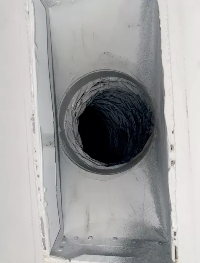 A close up of a duct with a hole in it.