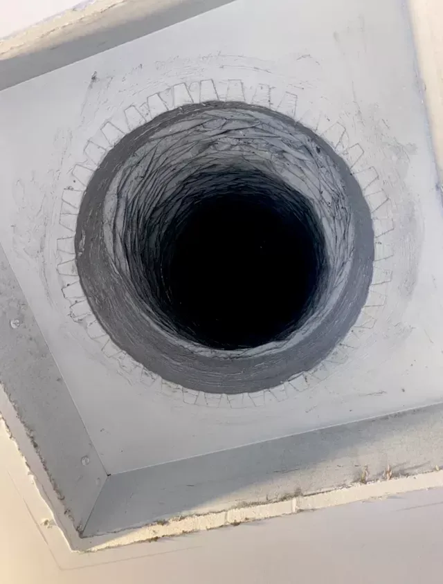 A close up of a hole in the ceiling of a building.