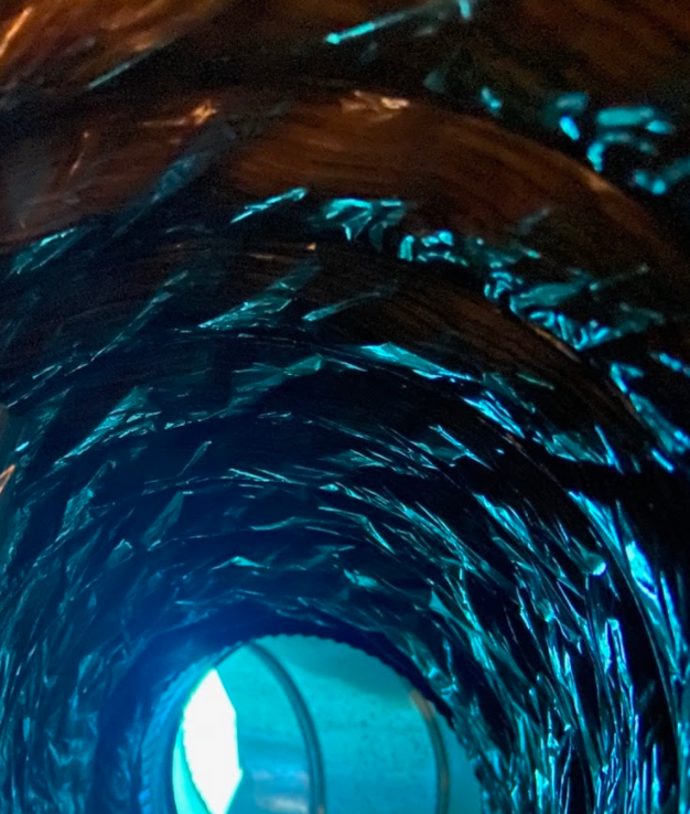 A blue tunnel with a light at the end