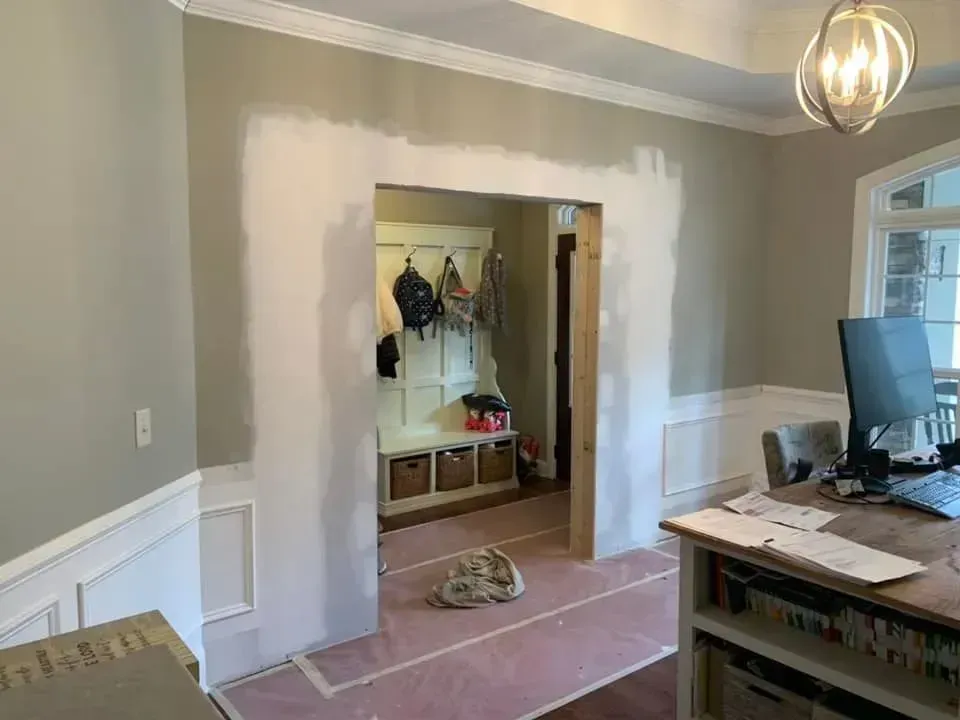 A room with a desk and a computer in it.