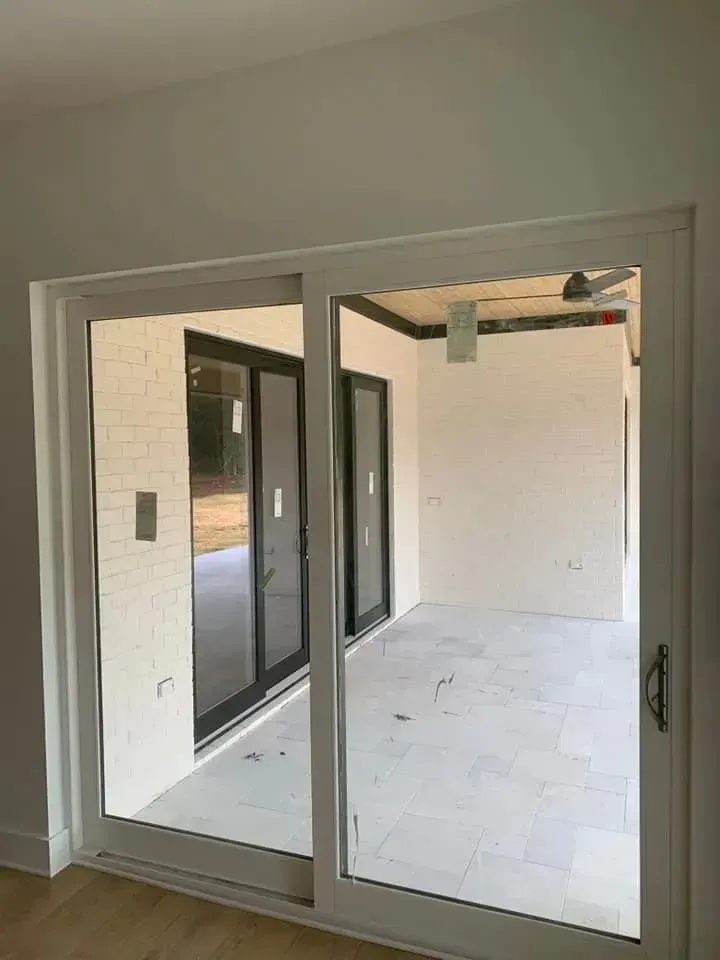 A room with sliding glass doors leading to a patio.