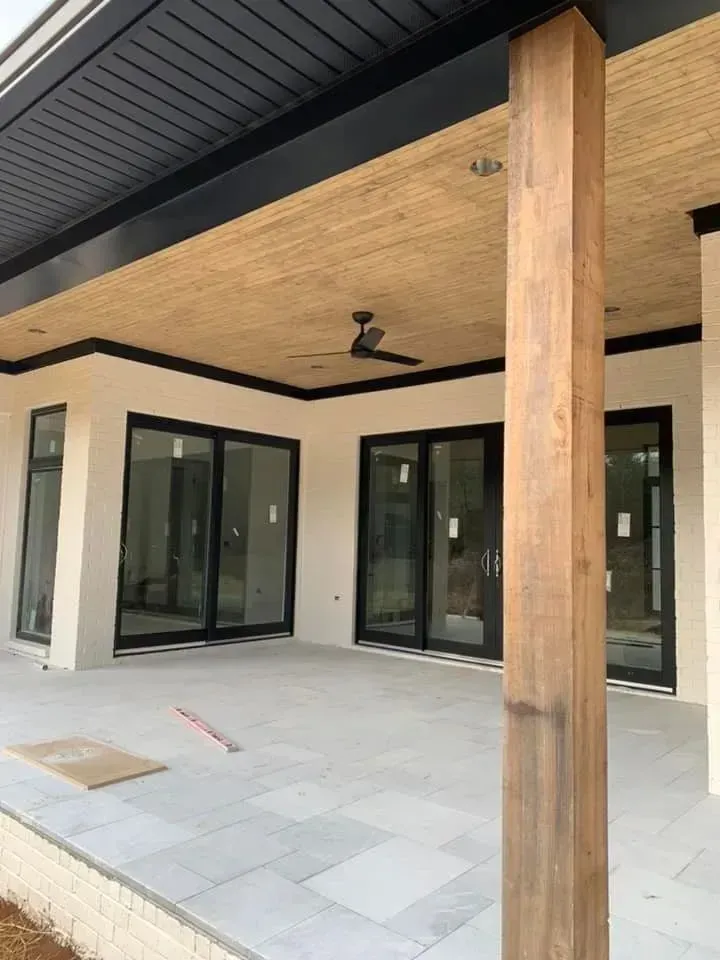 A patio with sliding glass doors and a ceiling fan