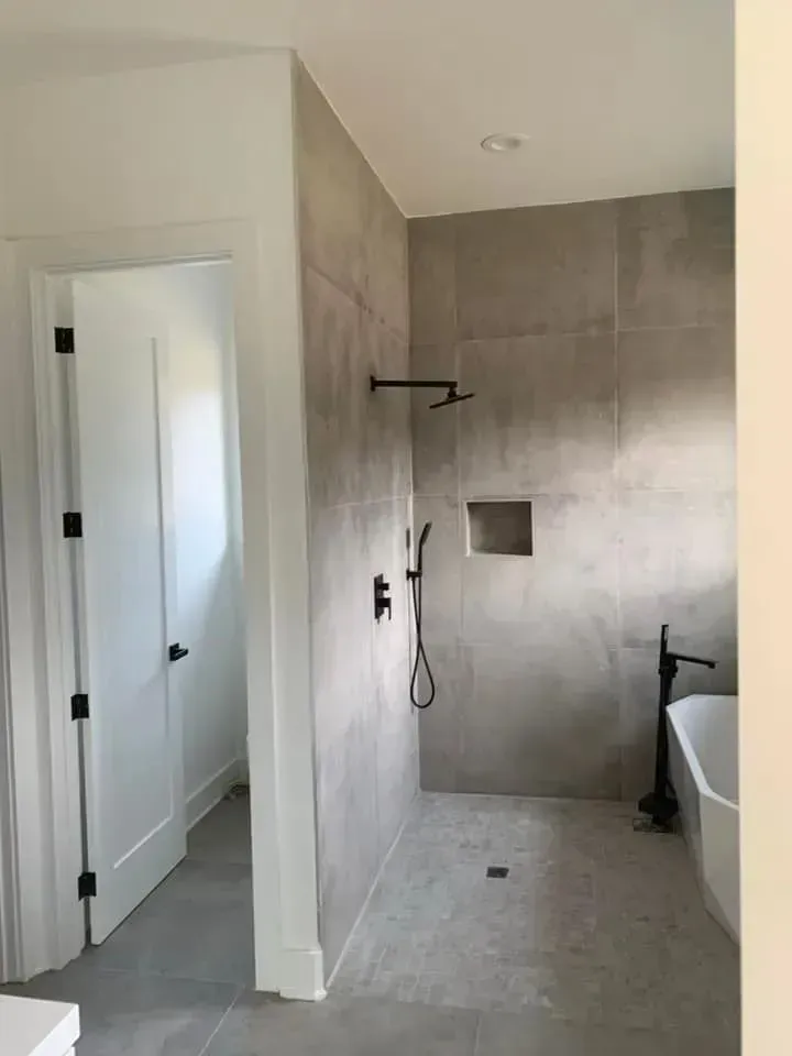 A bathroom with a walk in shower and a bathtub.