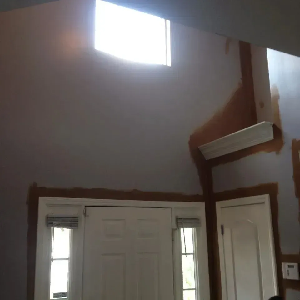 A room with white doors and a window with a light coming through it