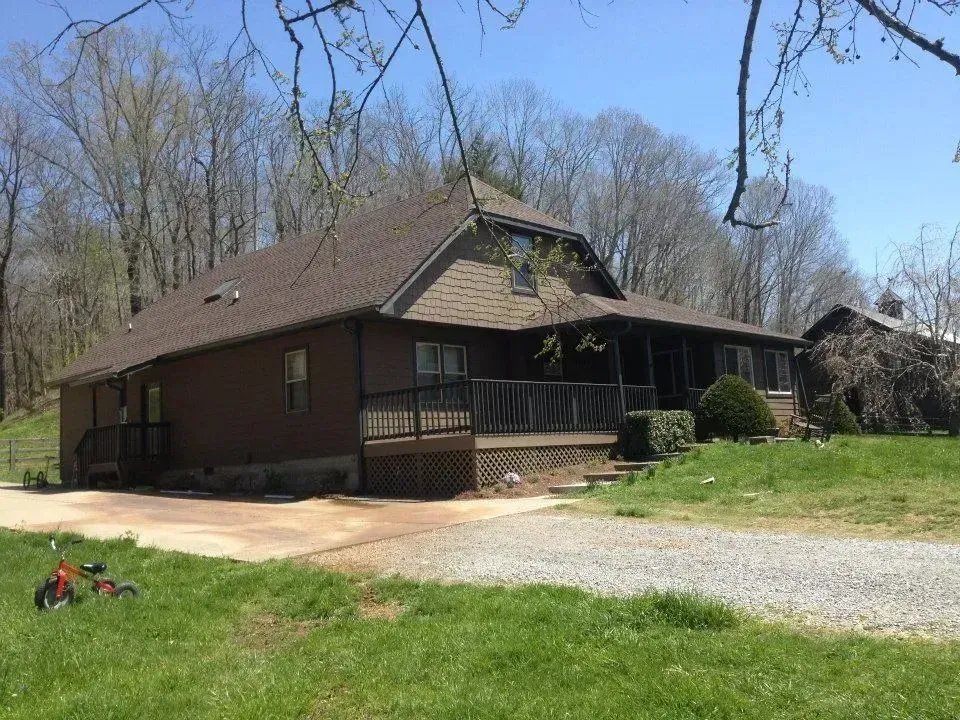 A house with a porch and a bicycle in front of it