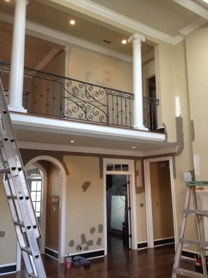 A room with a balcony and a ladder in it