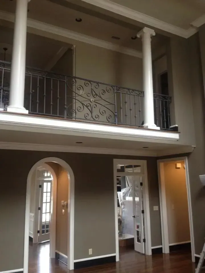 An empty house with a balcony and arches