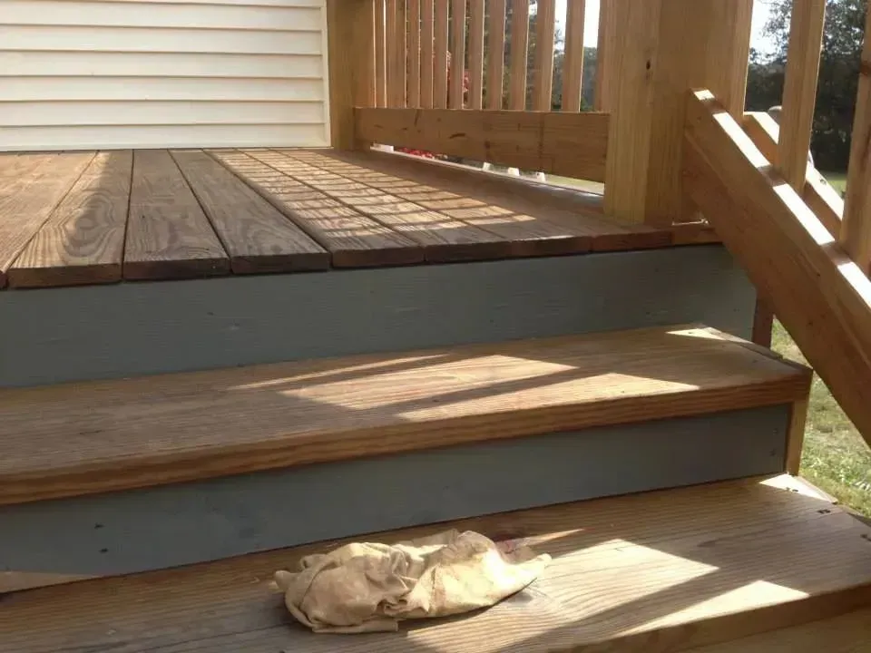 A wooden deck with stairs leading up to it