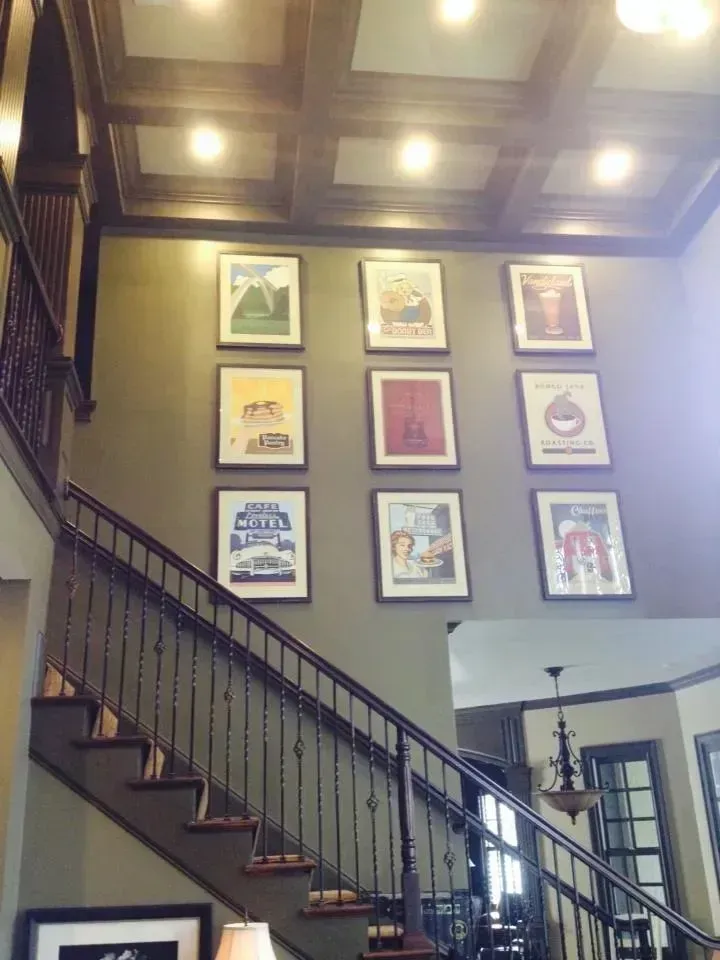 A staircase with pictures on the wall above it