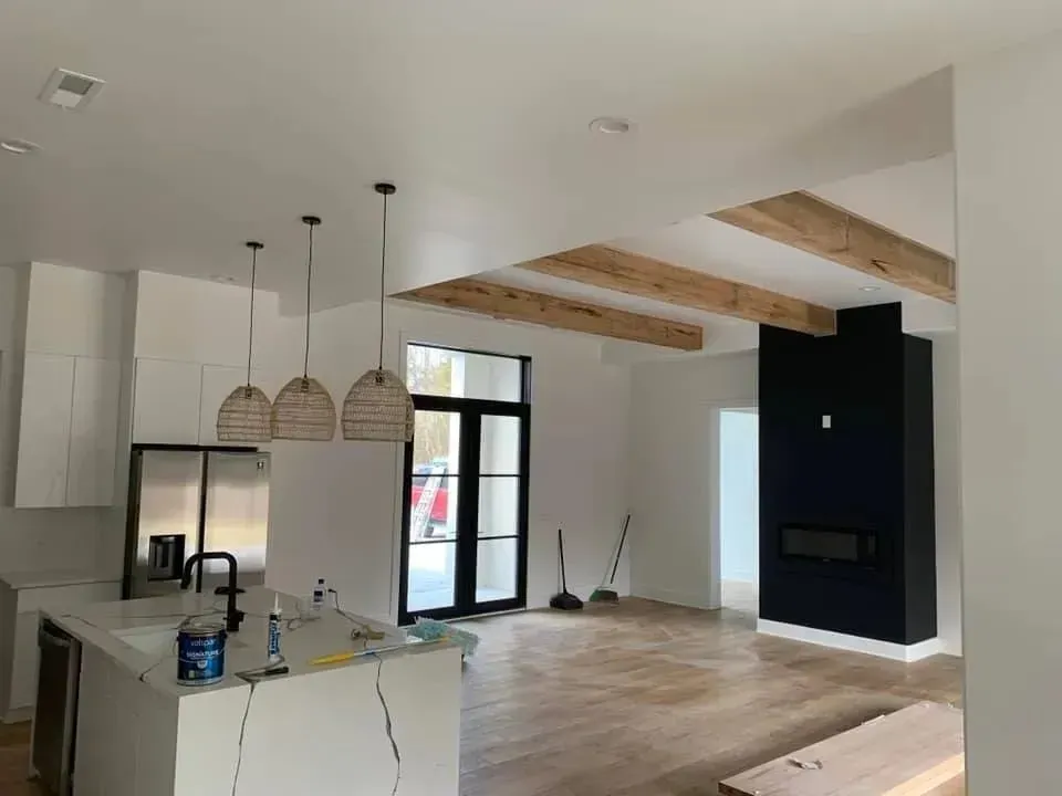 A kitchen and living room in a house under construction.