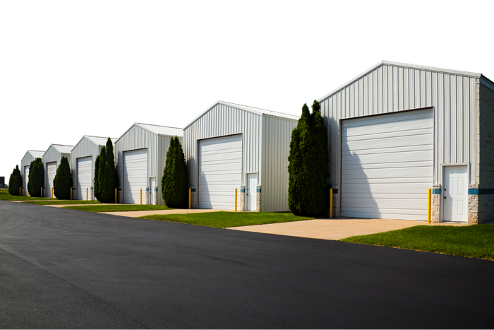 A row of white buildings with white garage doors