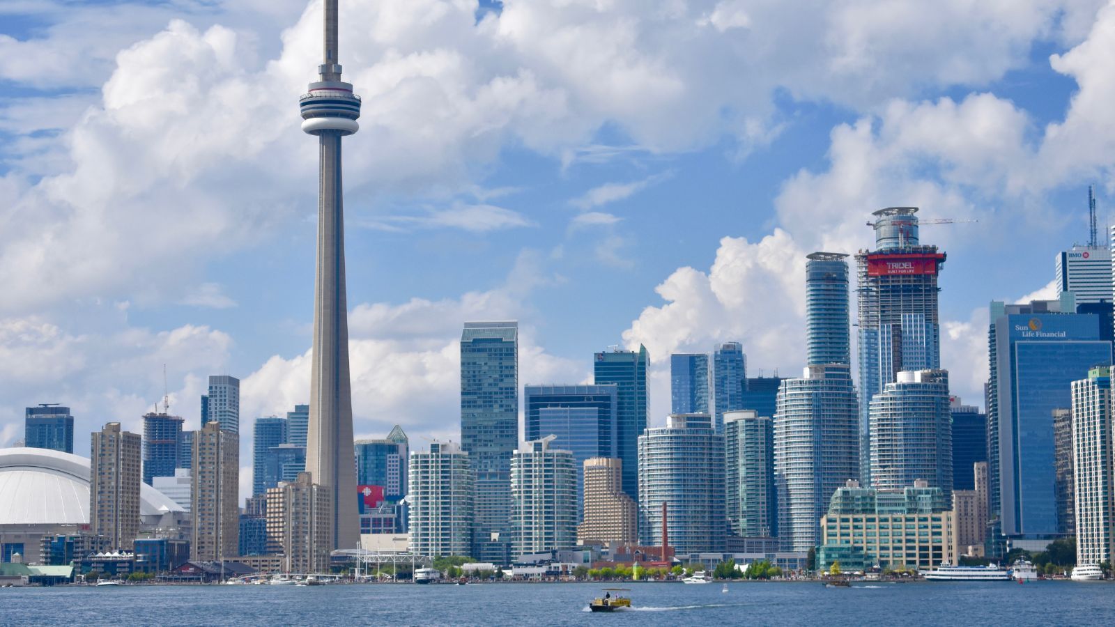 Cozy living room with a brown sectional sofa, wooden accents, and a jute rug.
