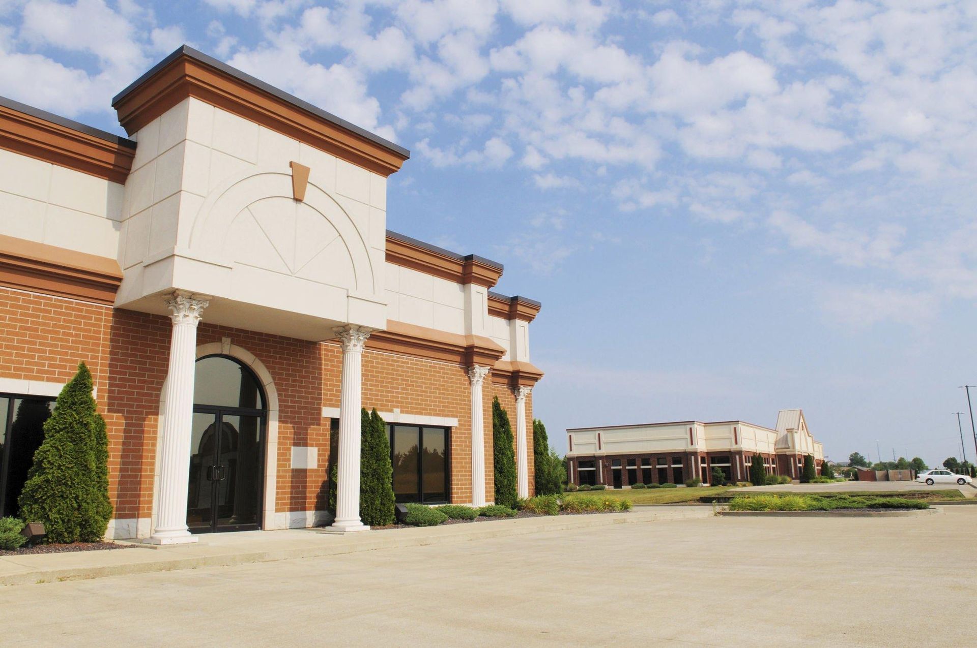 A large brick building with a white trim and columns