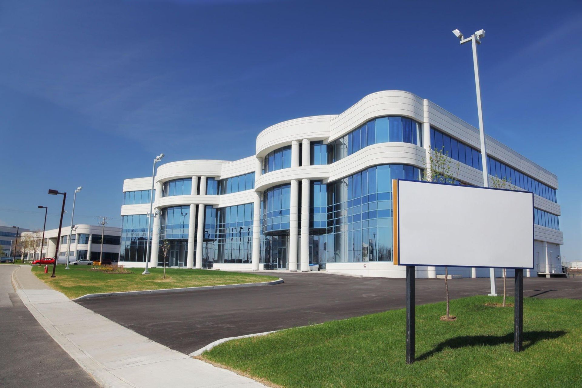 A large building with a white sign in front of it.