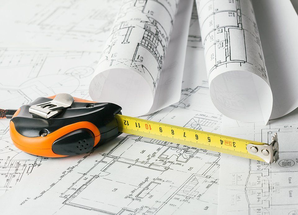 Tape measure over a construction plan drawing