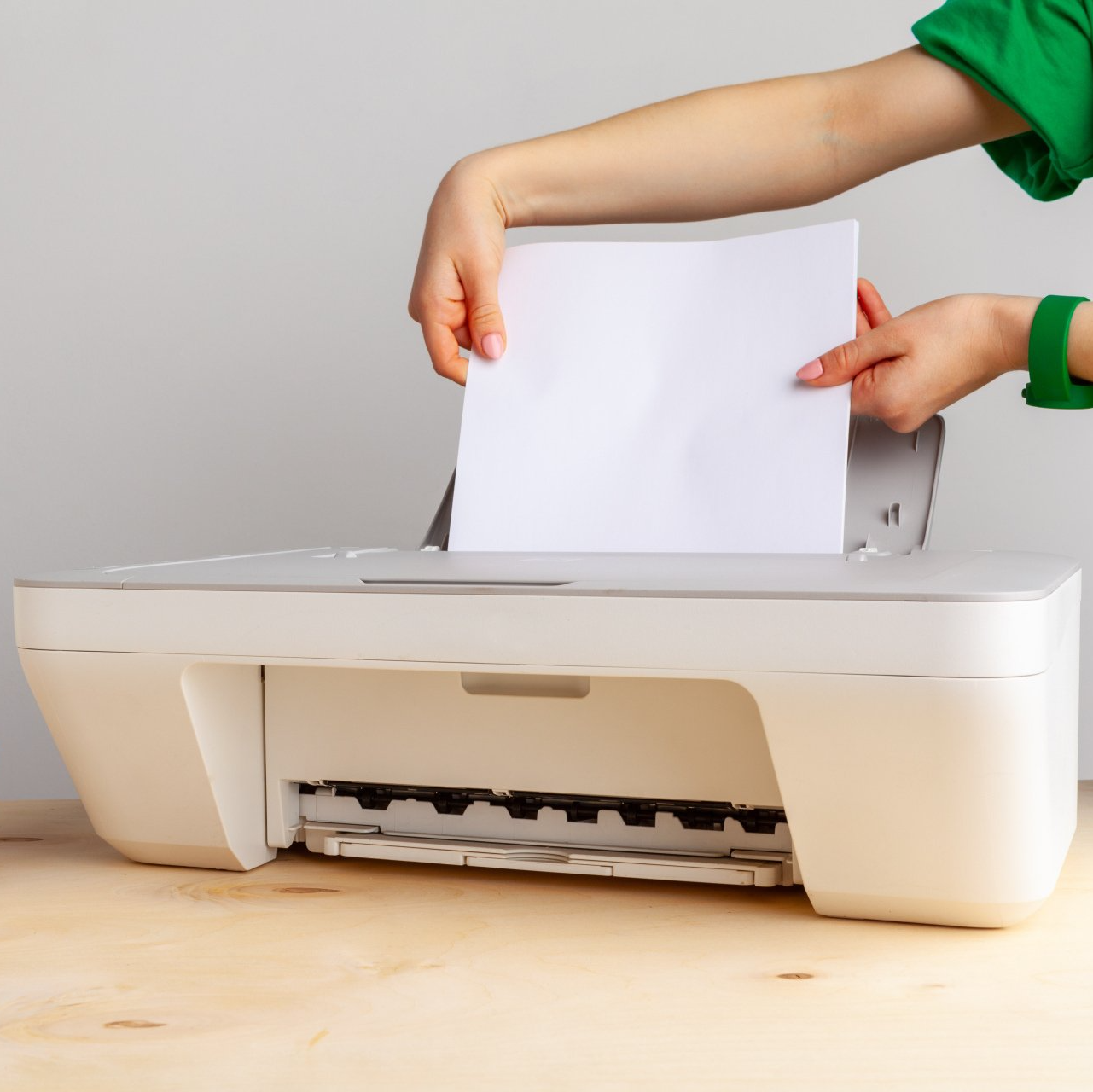 woman loading piece of paper into epson printer