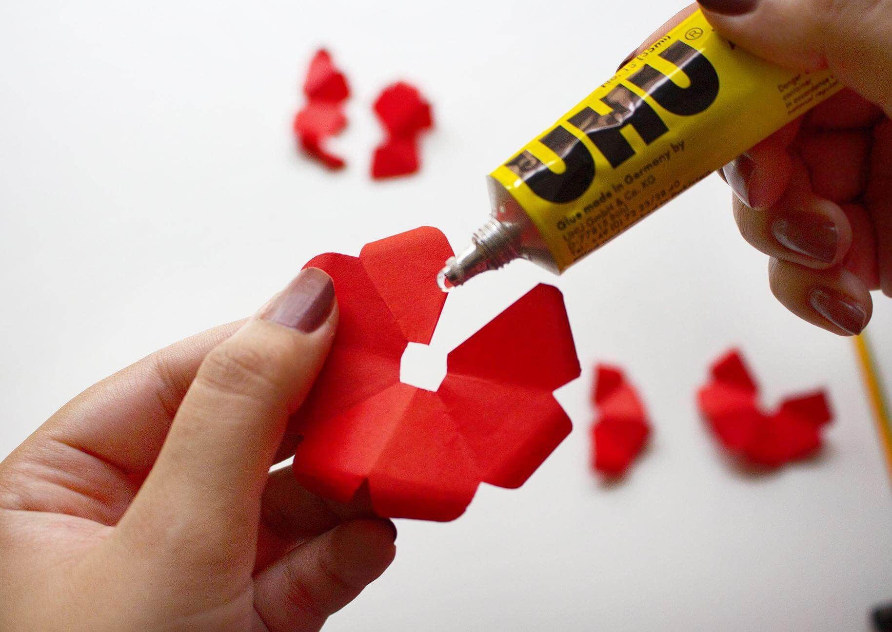 Woman putting glue on the flower