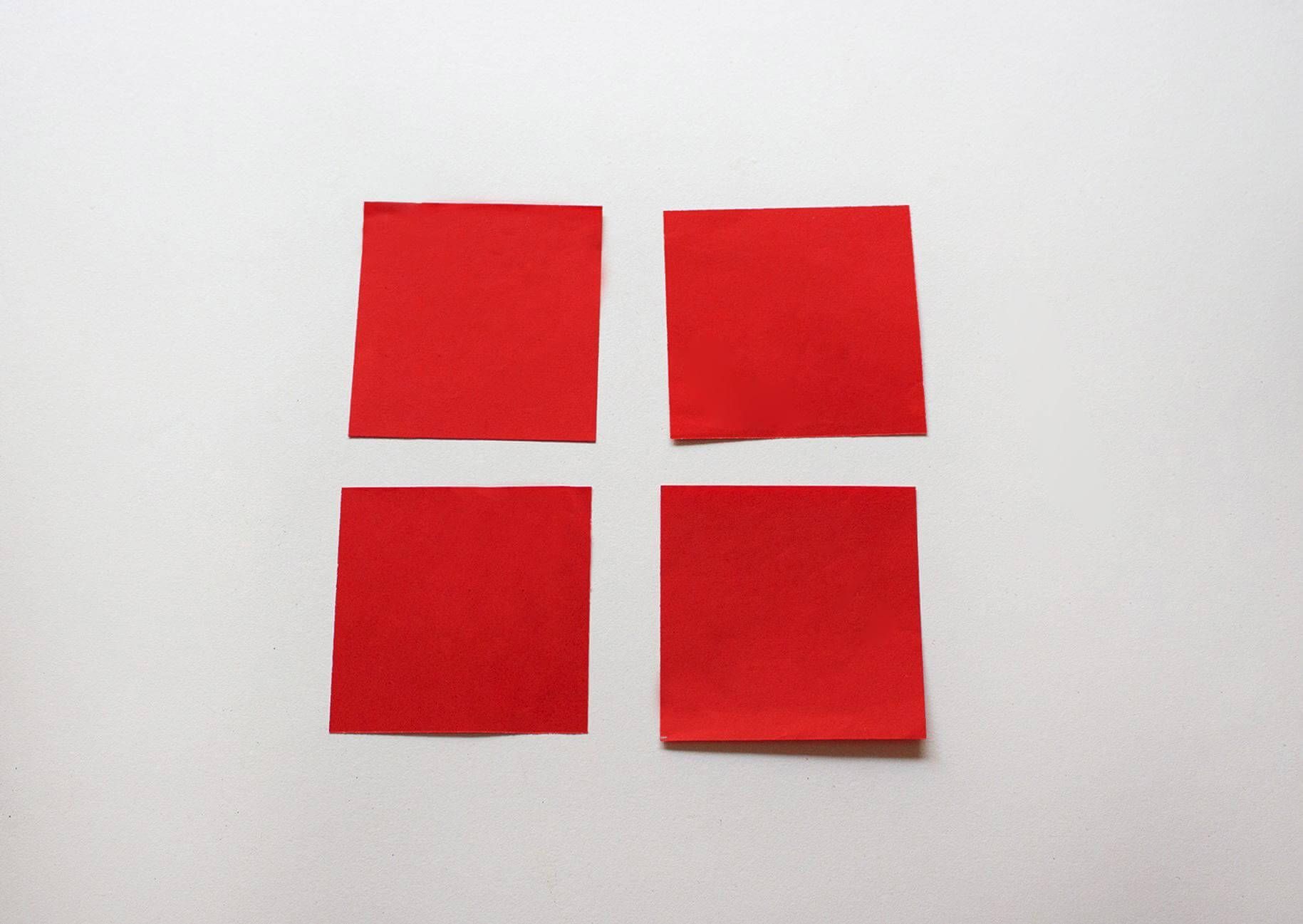 four square pieces of red paper