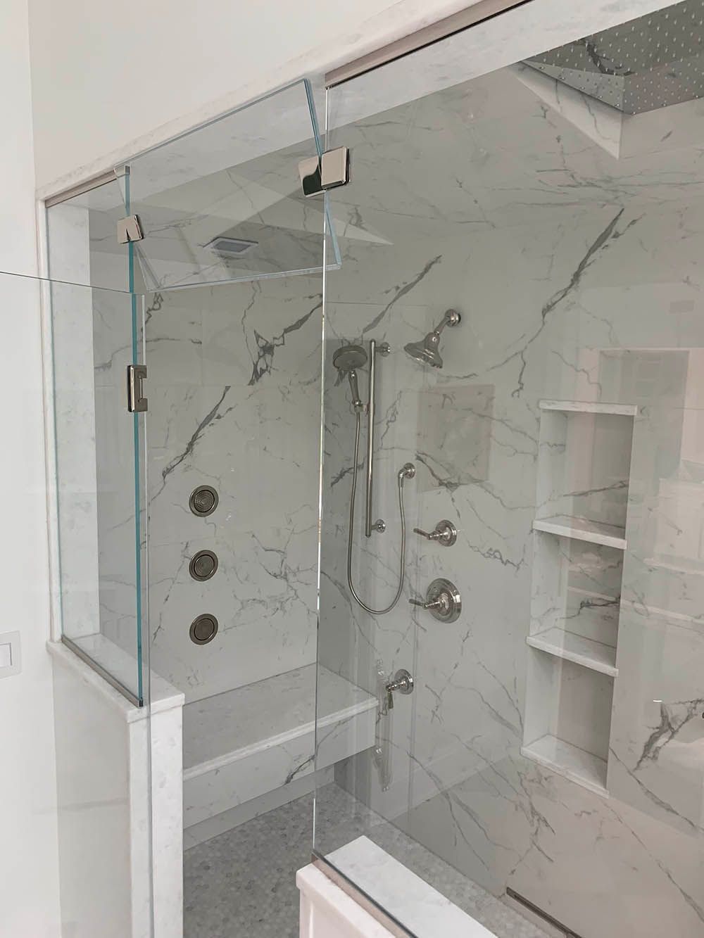 A bathroom with a walk in shower and a bathtub.