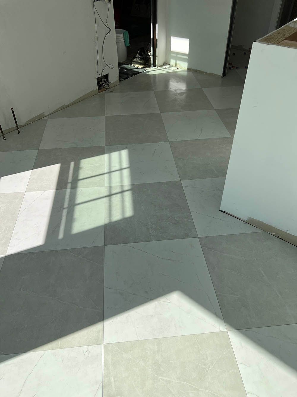 A room with a checkered floor and a window