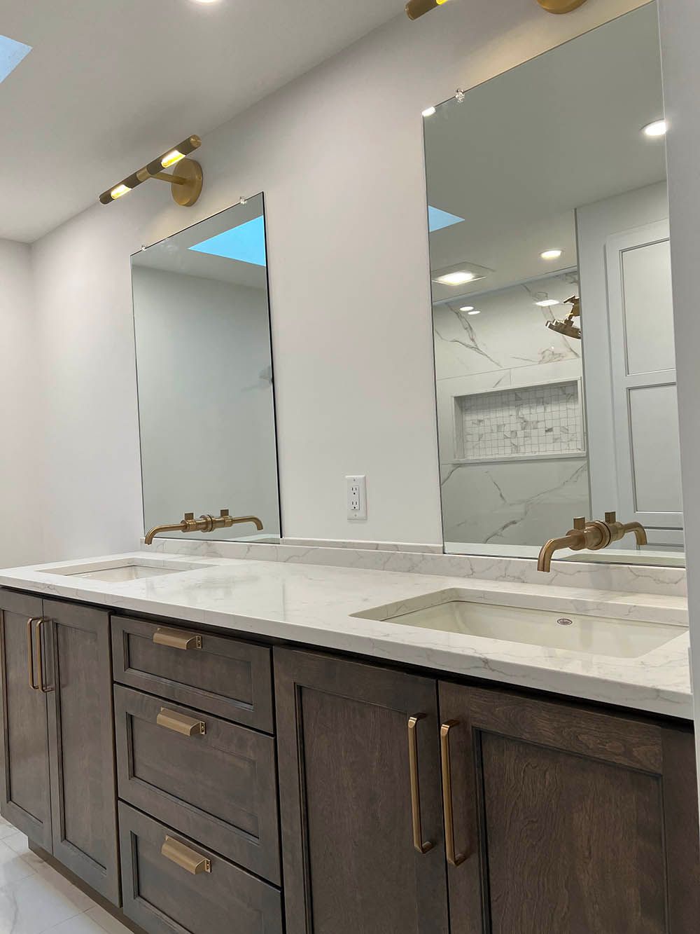 A bathroom with two sinks and two mirrors.