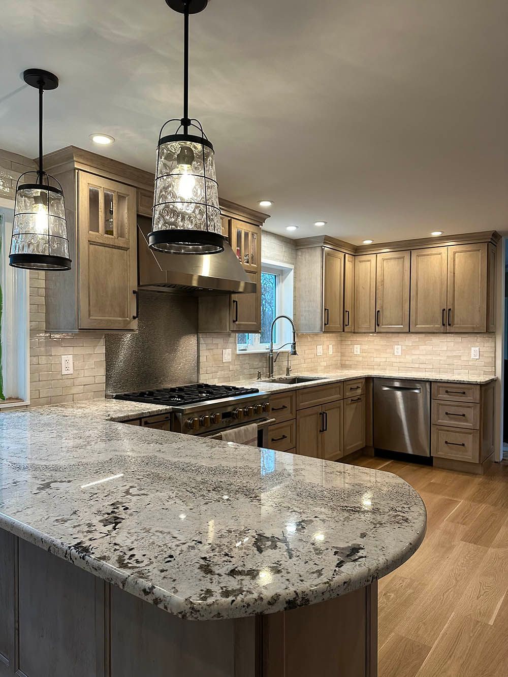 A kitchen with granite counter tops and stainless steel appliances.