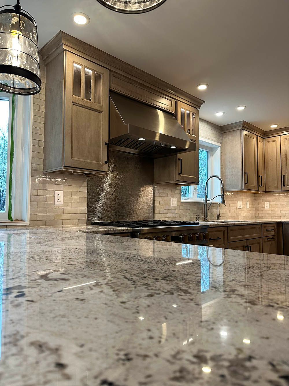 A kitchen with stainless steel appliances and granite counter tops.