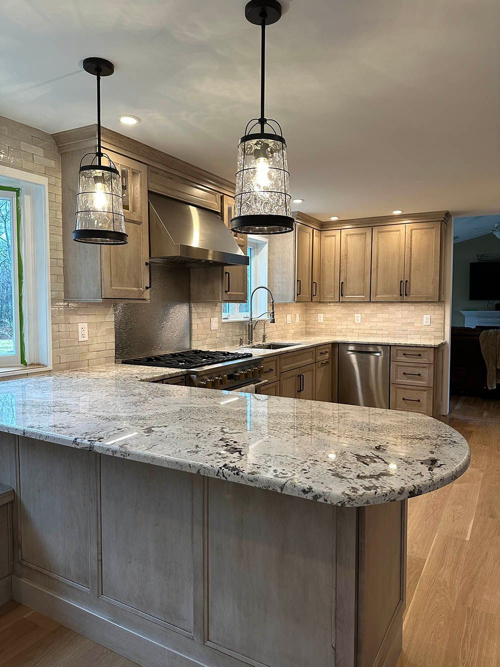 A kitchen with granite counter tops and stainless steel appliances.