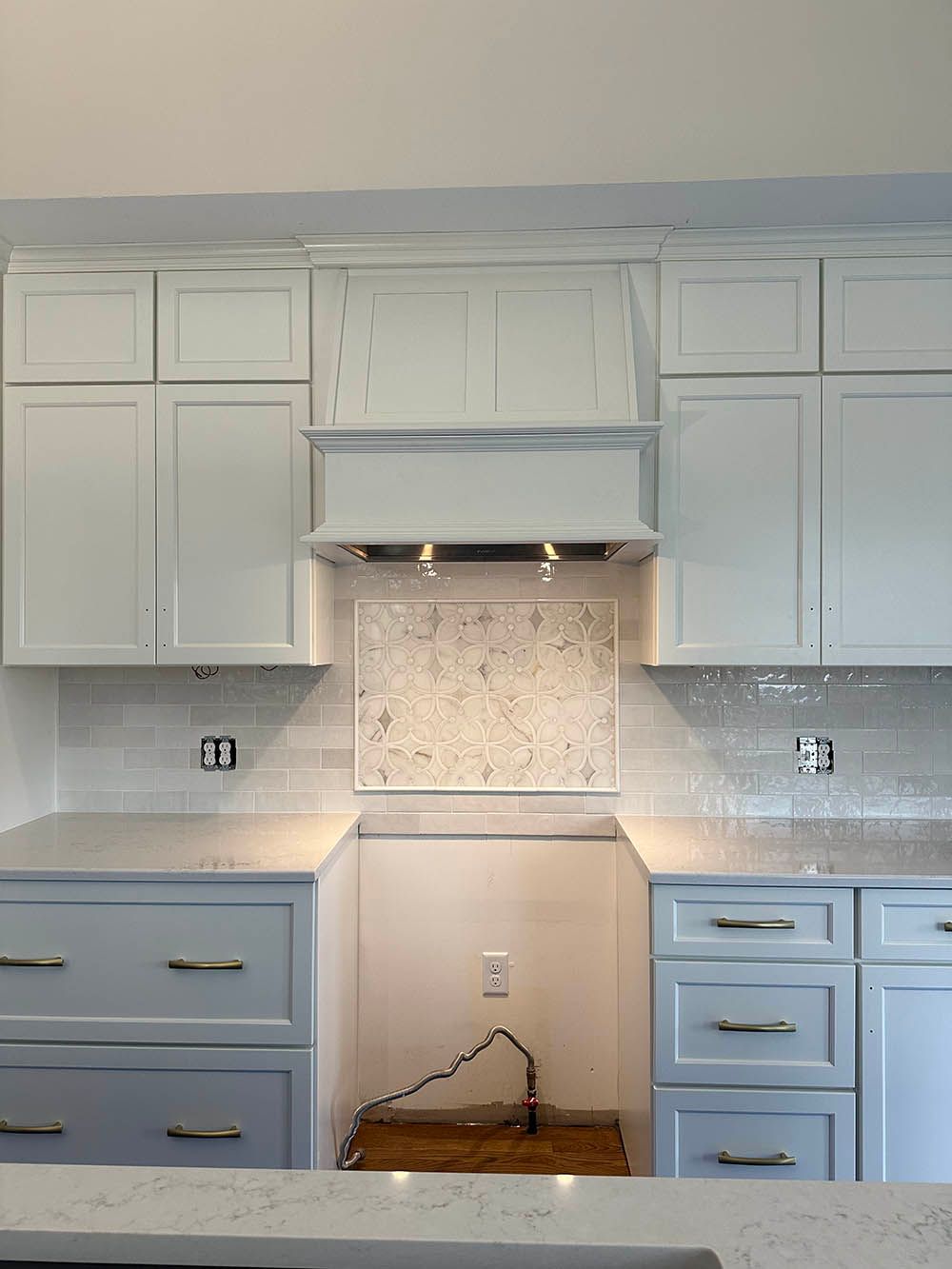 A kitchen with white cabinets and white counter tops