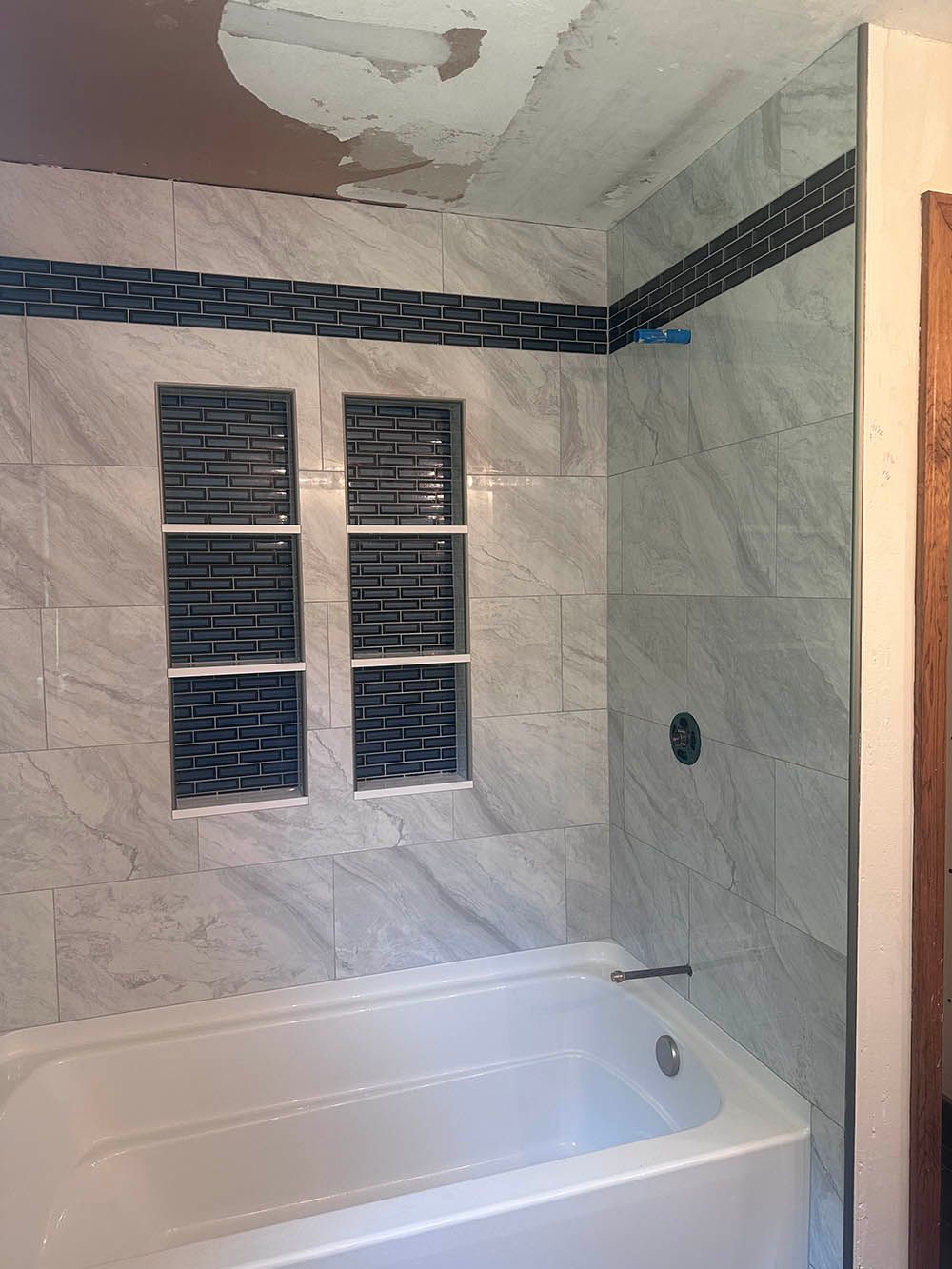 A bathroom with a bathtub and a shower stall.