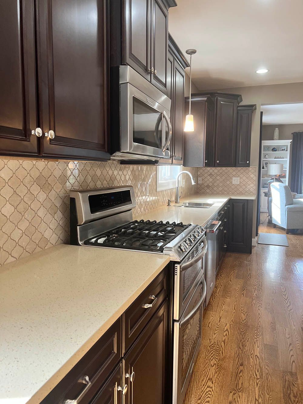A kitchen with brown cabinets and stainless steel appliances