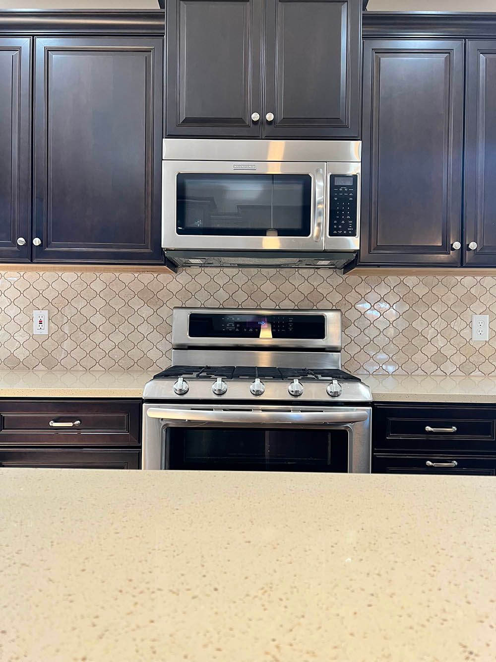 A kitchen with a stove top oven and a microwave