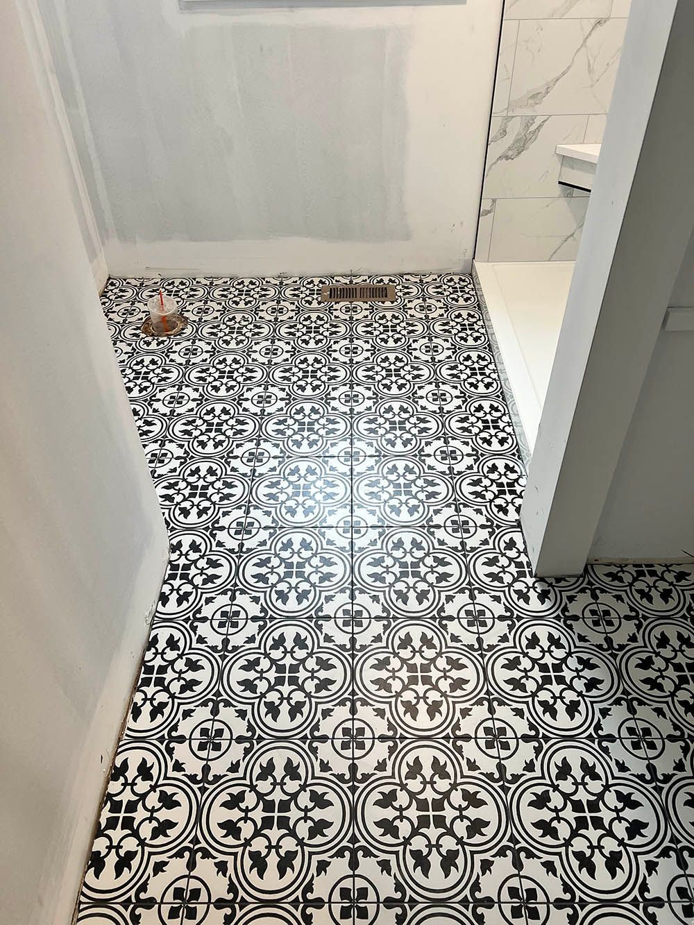 A black and white tile floor in a bathroom.