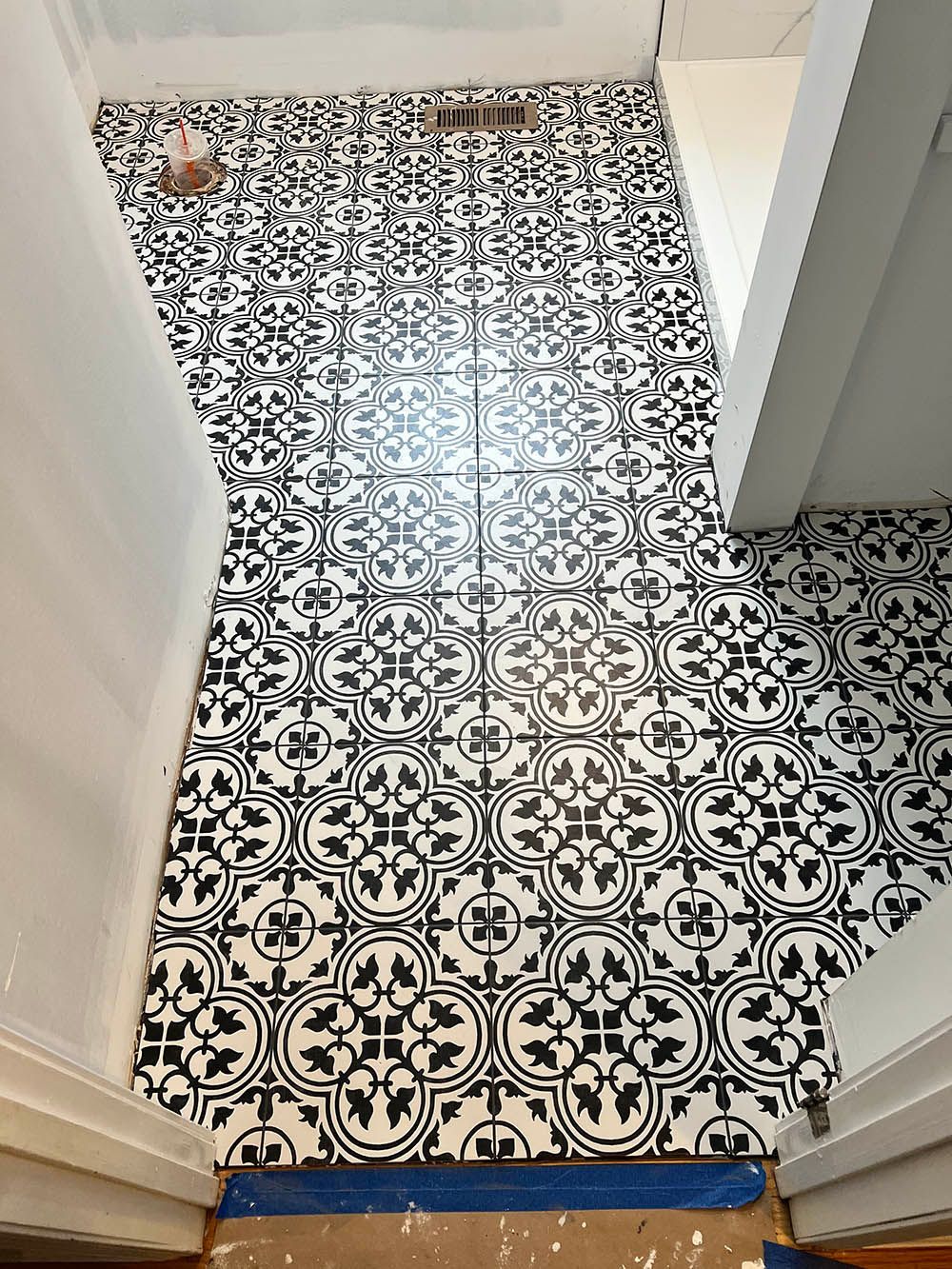 A black and white tile floor in a bathroom.