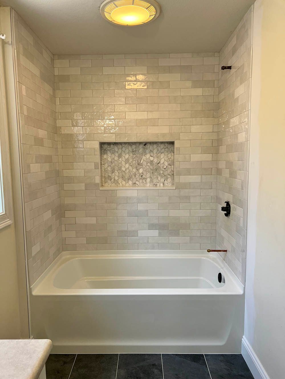 A bathroom with a bathtub and a shower.