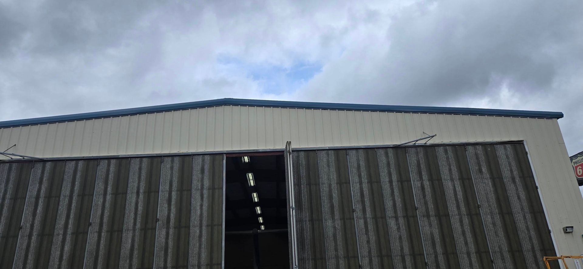 A commercial building with a cloudy sky above it.