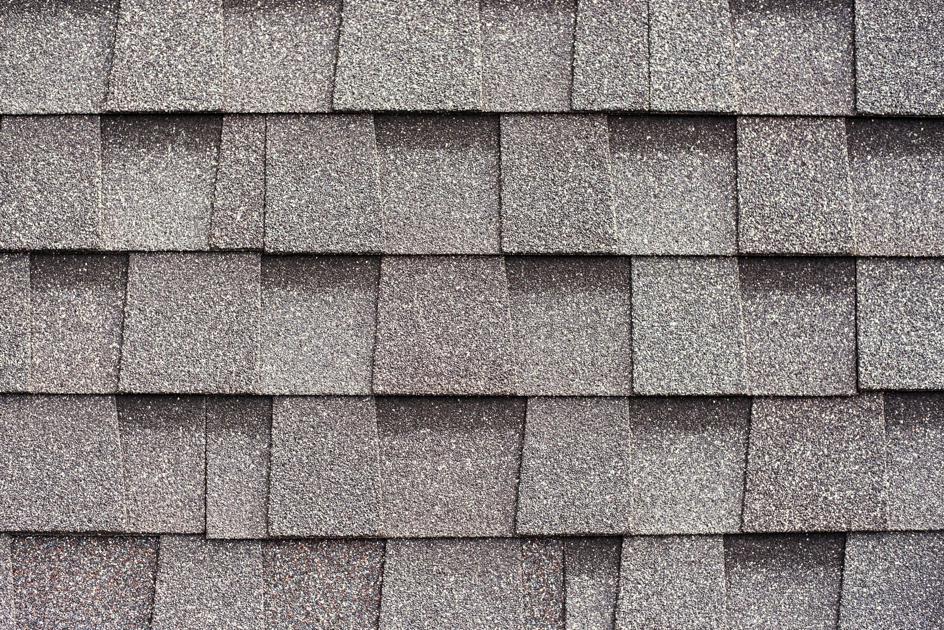 Close-up of gray asphalt roof shingles.