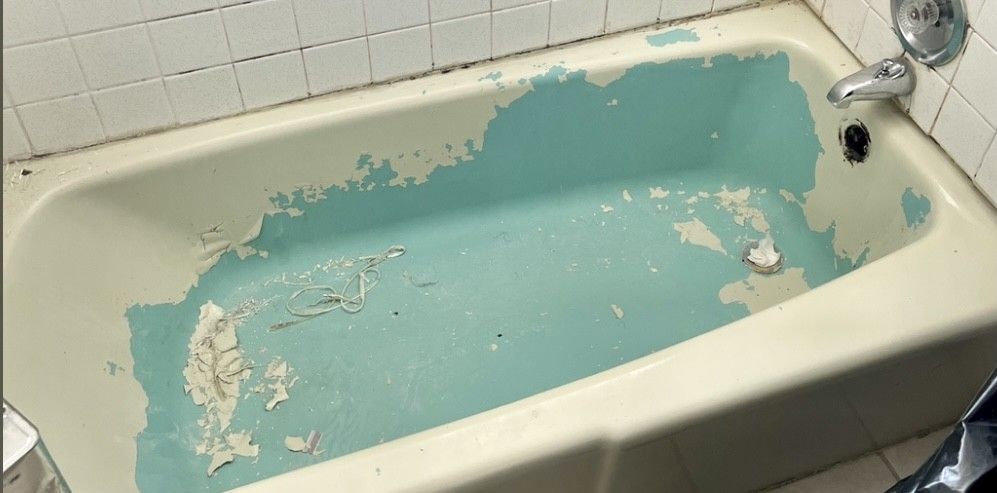 A bathtub that has been painted blue is sitting in a bathroom.