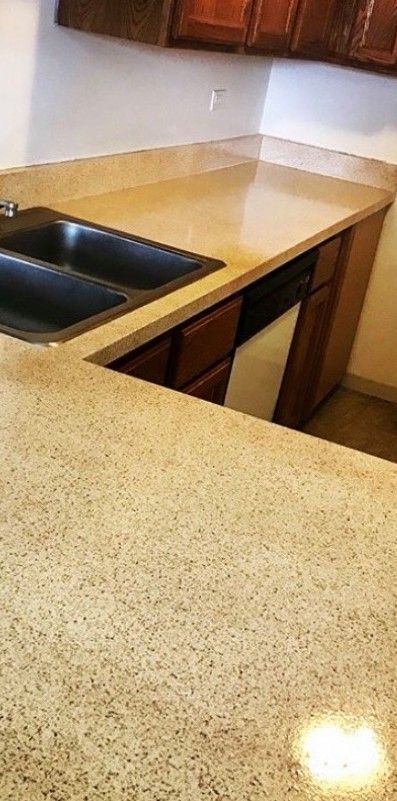 A kitchen with two sinks and a granite counter top.