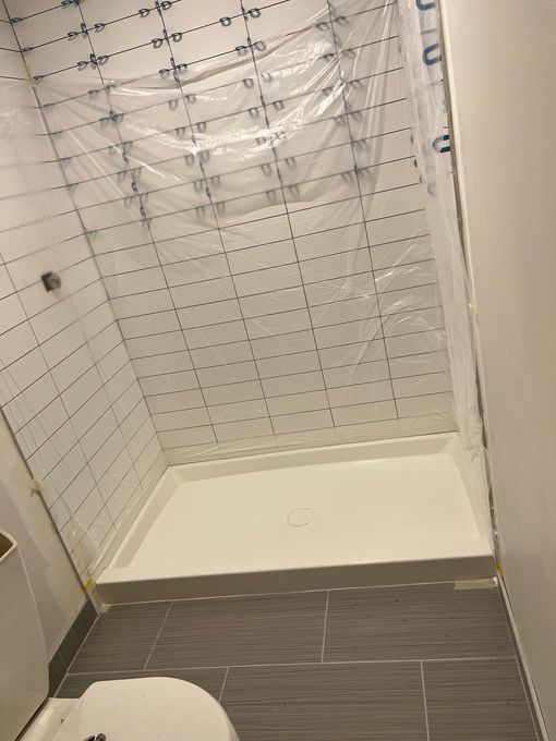 A bathroom with a walk in shower and a toilet.