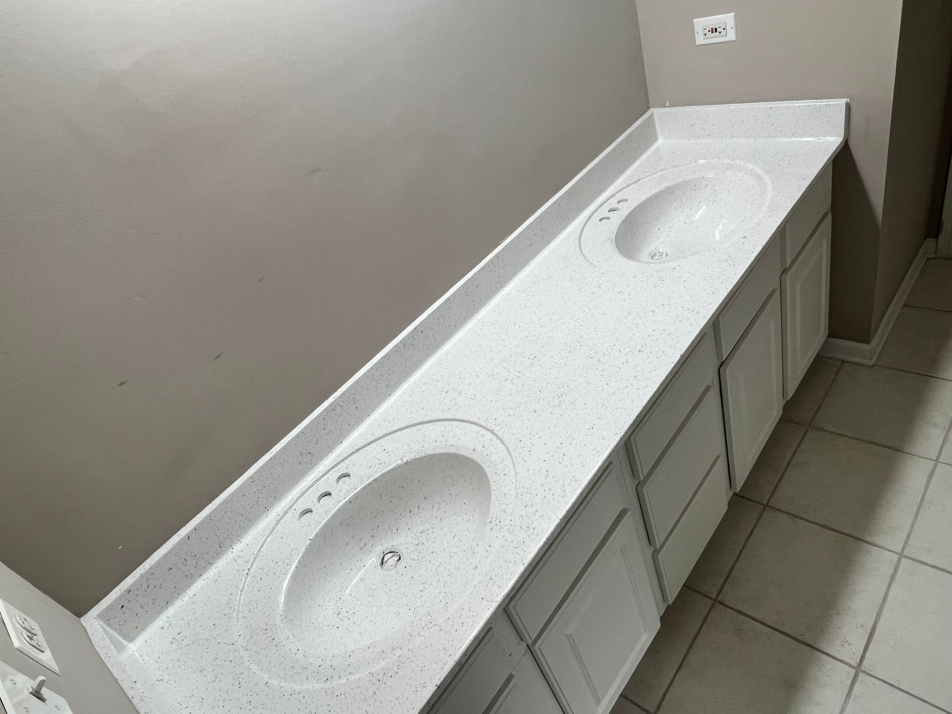 A bathroom with two sinks and two mirrors.