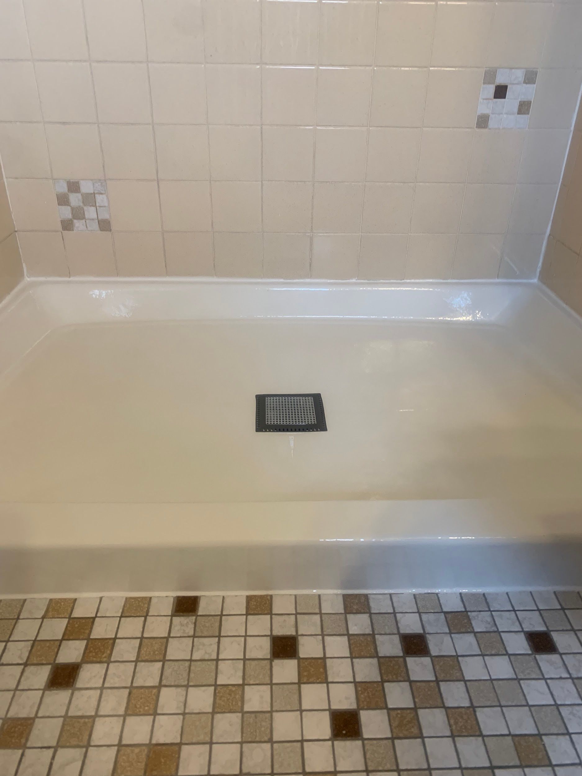 A bathroom with a bathtub and a tiled floor.