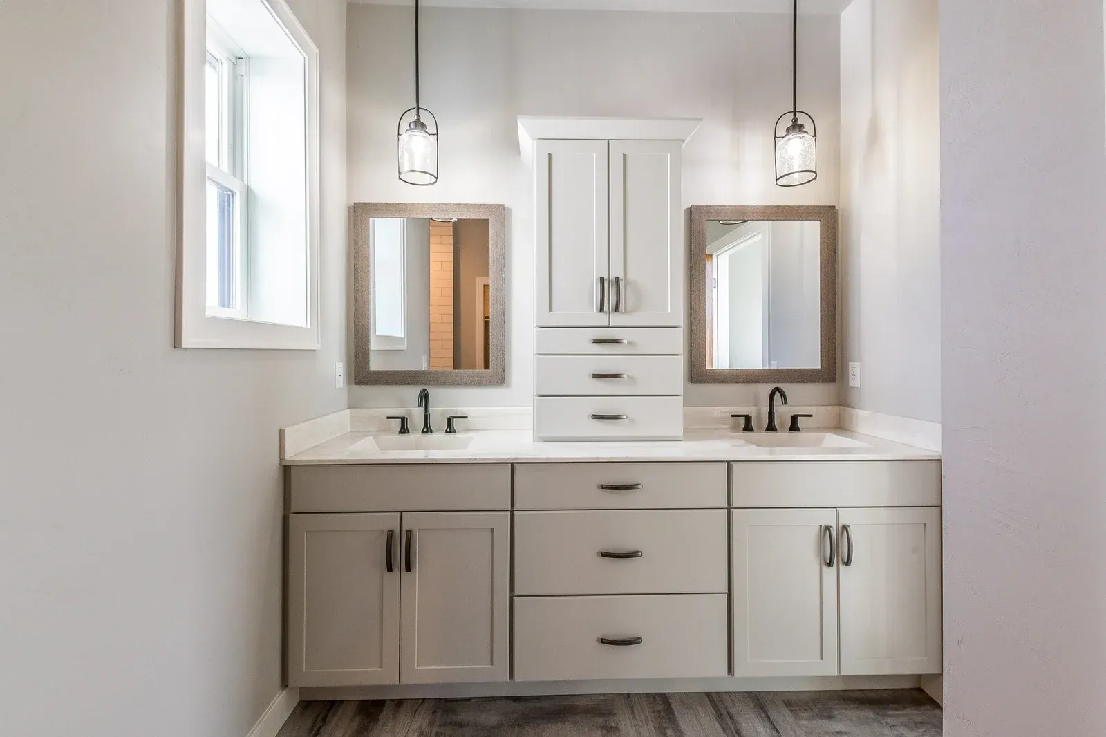 A bathroom with two sinks and two mirrors.