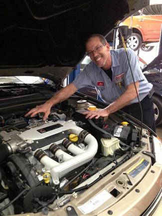 Mechanic Under Car Hood | Jenkins Automotive