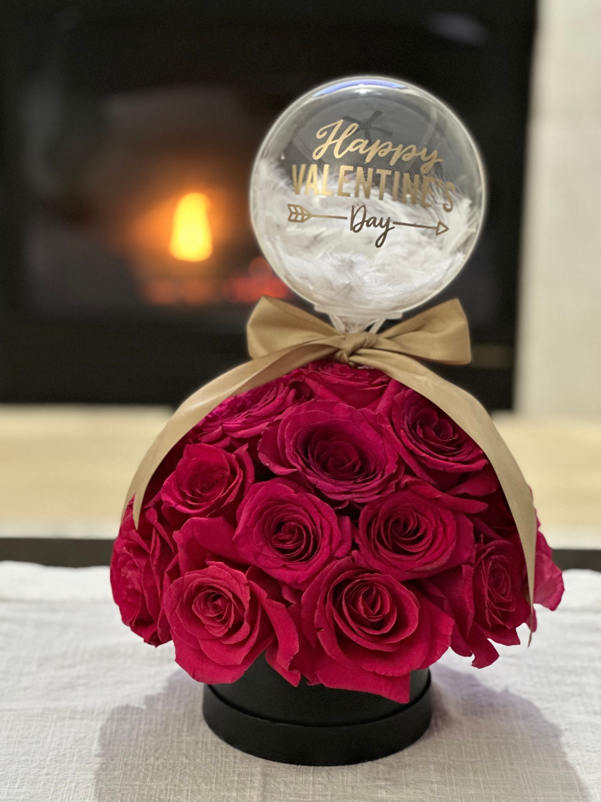 Red rose arrangement in a black box with a 