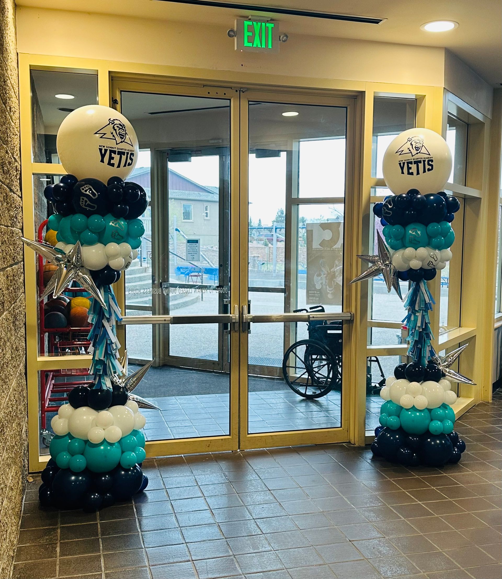 Two balloon columns flank double doors. Each column has a 
