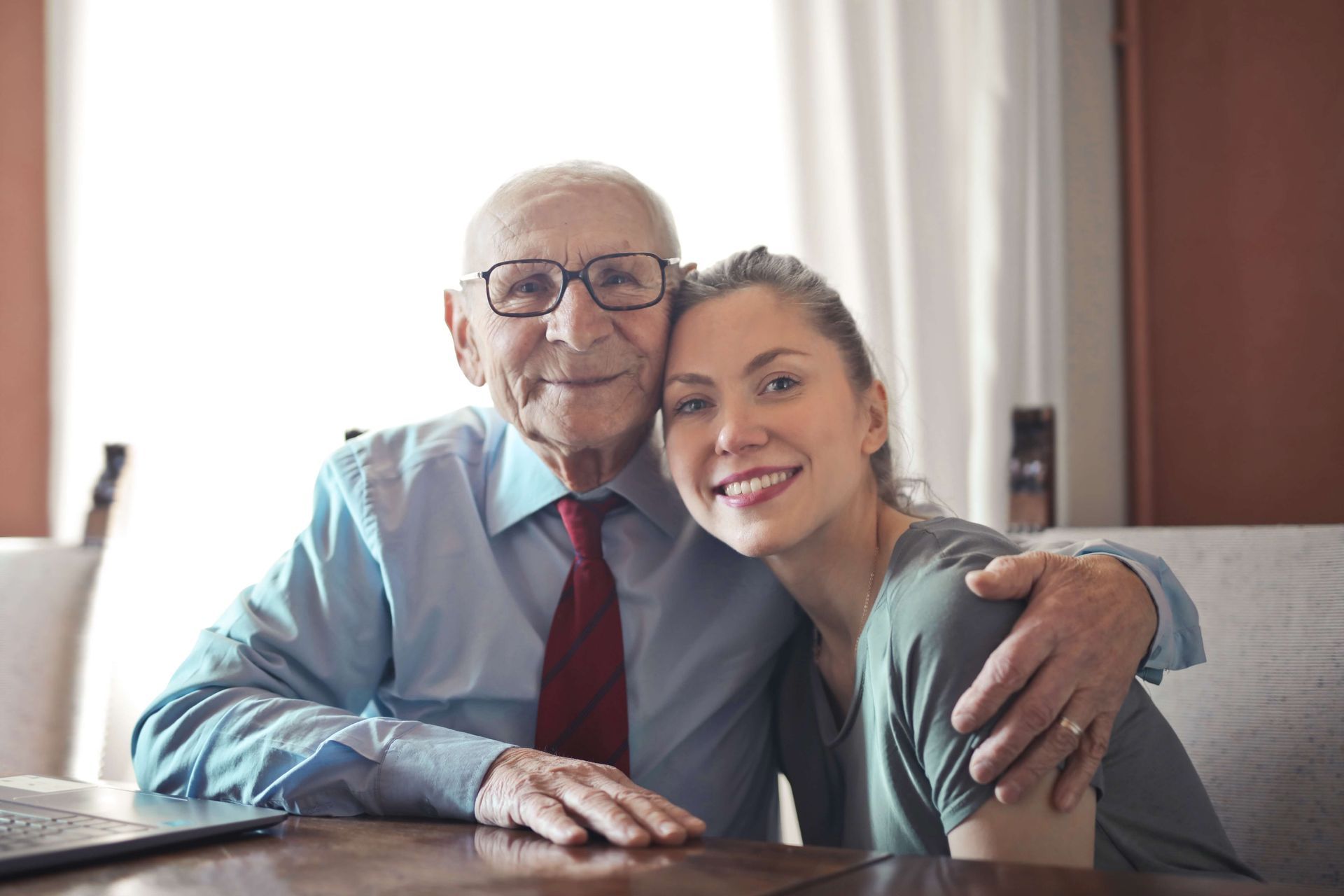 Happy elderly man hugging lady