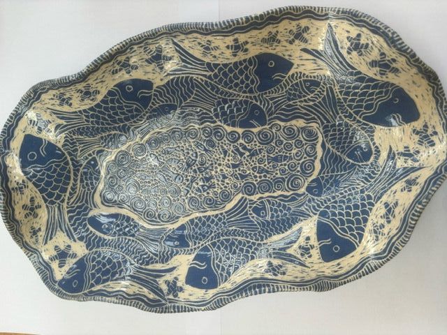 Large sgraffito platter by ceramic artist Jenny Morrish features blue and white fish and crab design on reverse