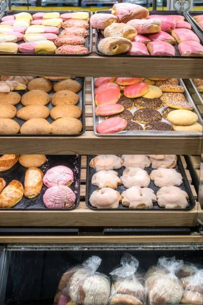 A variety of pastries are on display in a bakery.