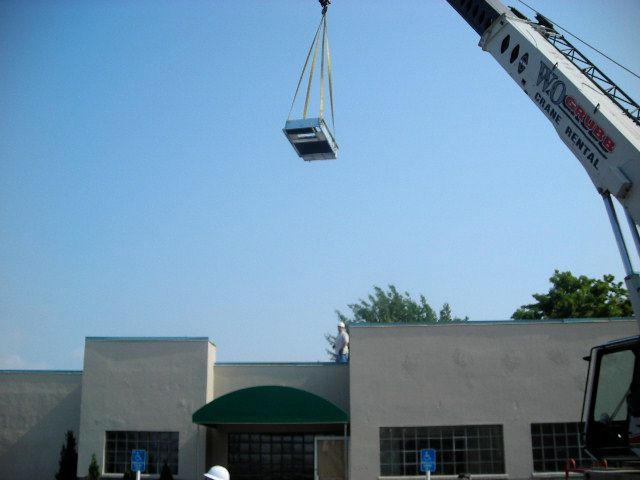 A Crane Lifting Up An Object — Emporia, VA — Sunrise Heating & Air Conditioning